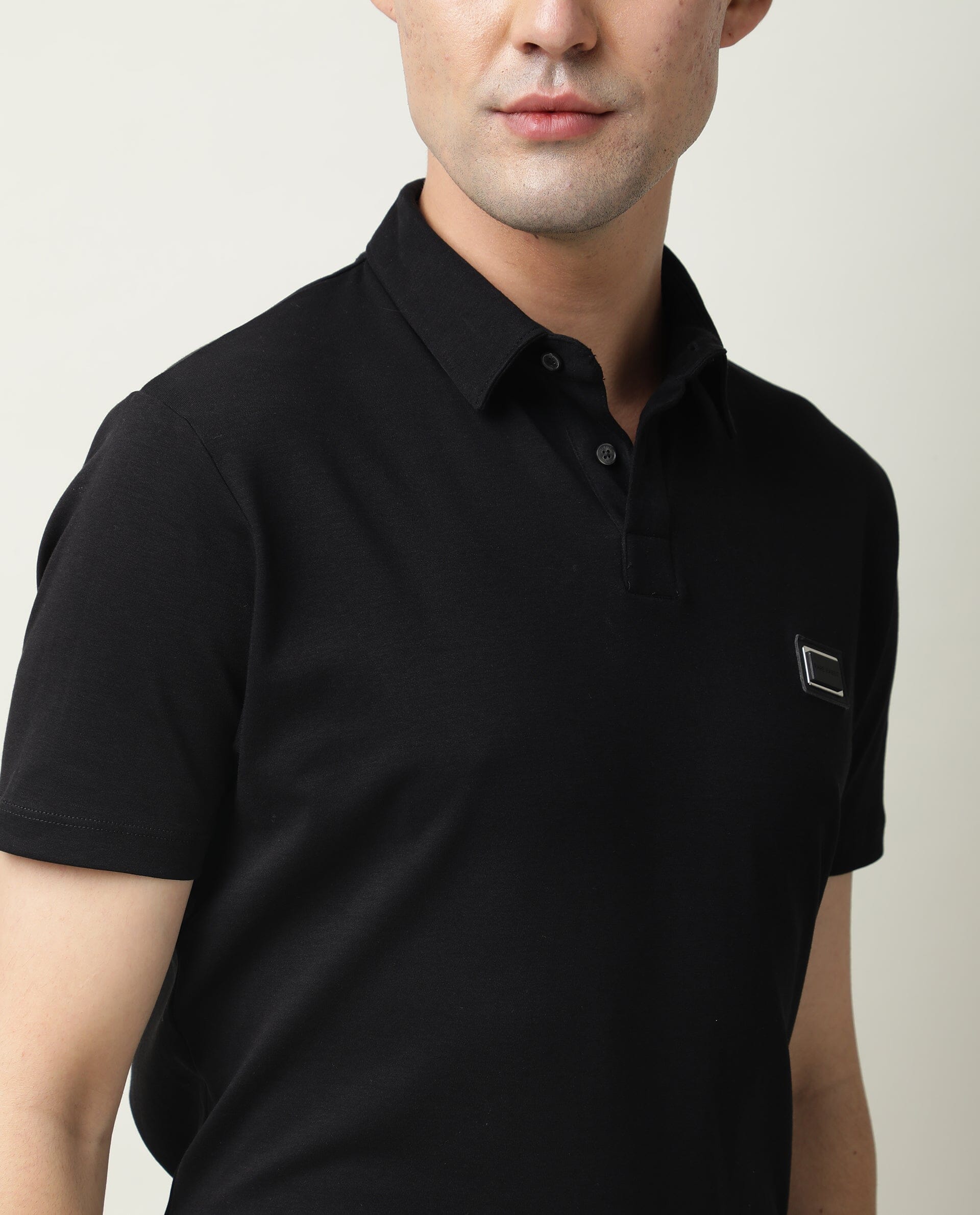 Rare Rabbit Men's Badge Black Cotton Fabric Collared Neck Half Sleeves Polo T-Shirt